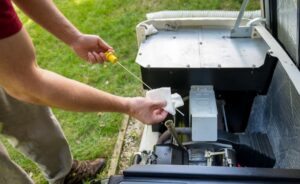 Maintenance technician testing generator fluid levels 