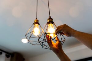 Electrician hanging antique lights