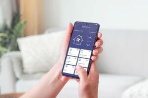 Homeowner using smart home app to control devices