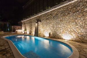 Modern swimming pool lit up at night