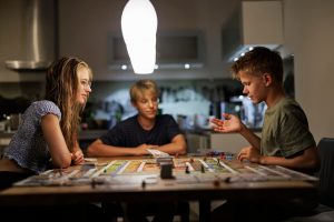 Kids playing board game during power outage