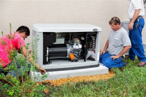 Three technicians installing generator outside residential home